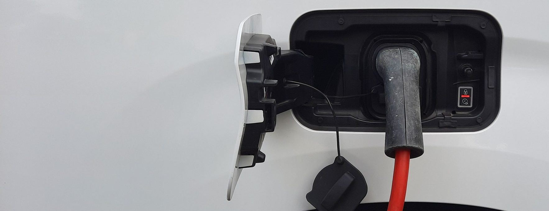 A white van plugged in to charge
