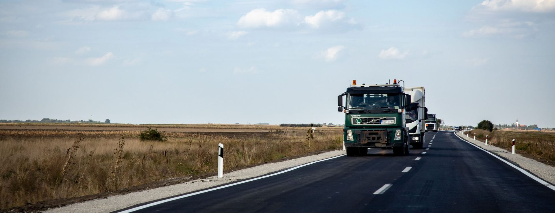 Lorries coming down an empty country road